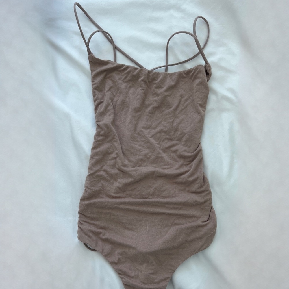 Criss cross back tan body suit